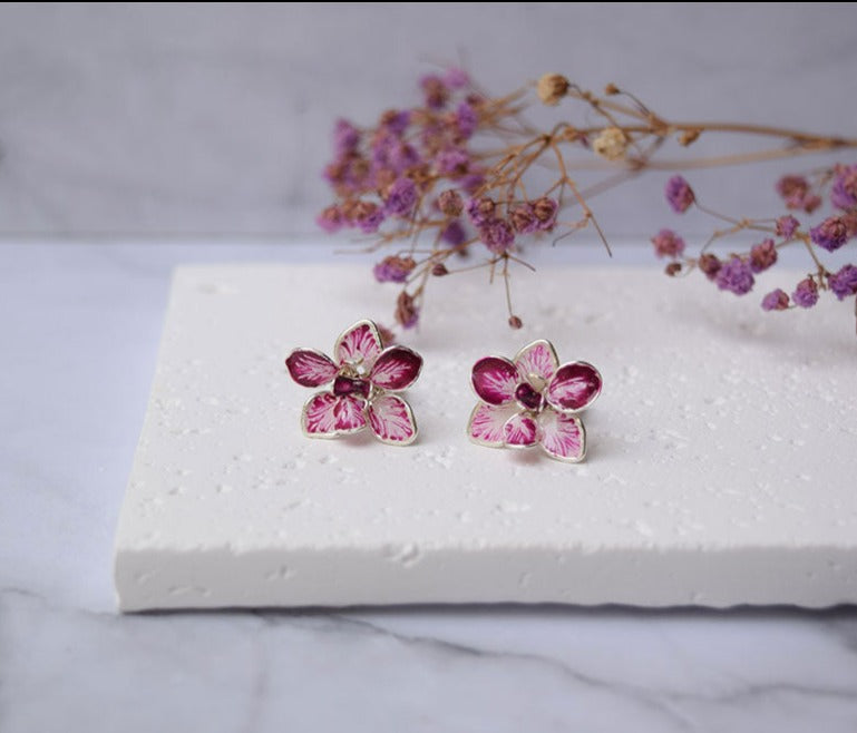 A hand formed and hand-painted Purple-White Orchid flower stud earrings.