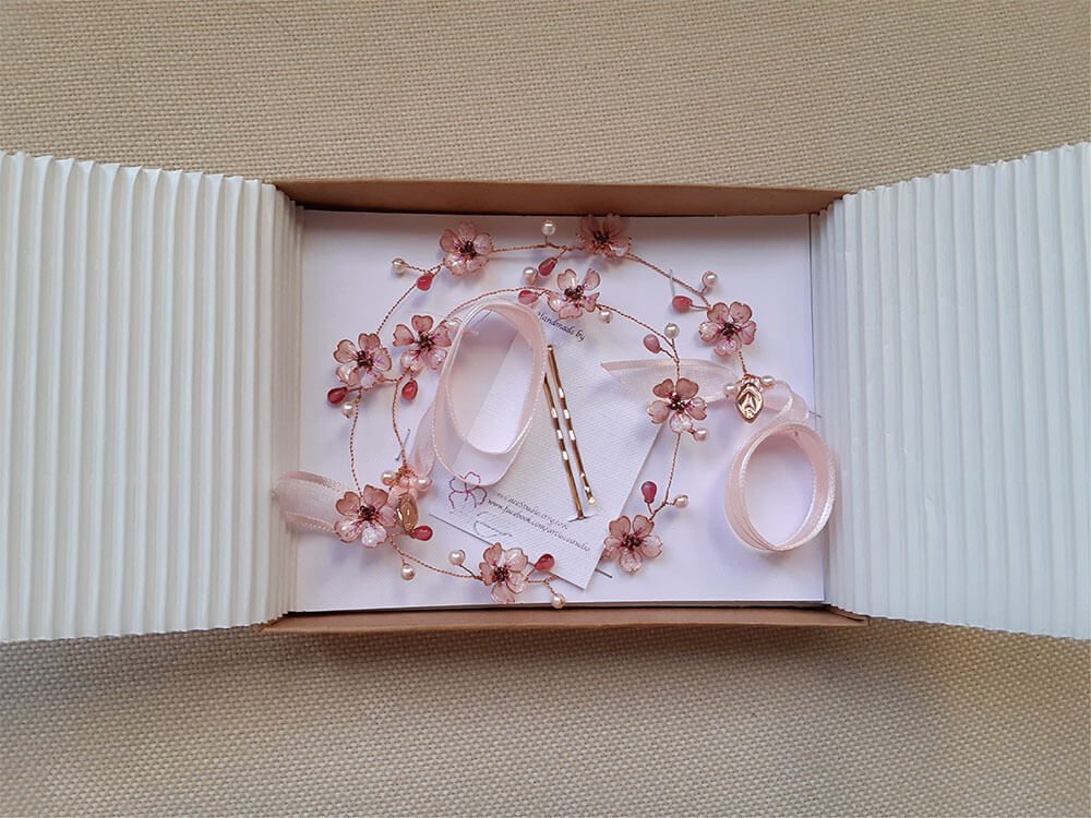 A Delicate 18 inches bridal hair vine in rose gold finish with handmade tiny Sakura/Cherry Blossom flowers in arranged in a row in combination with pink pearls and glass beads. A unique bridal pink hair wrap or hair garland in rose gold finish.